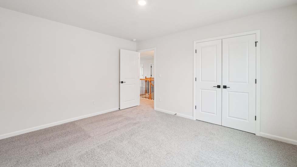 Carpeted bedroom with window