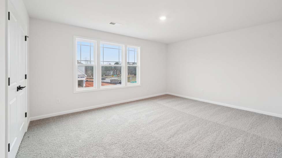 Carpeted bedroom with window