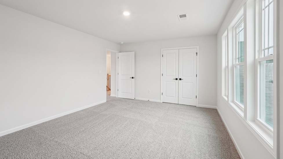 Carpeted bedroom with window