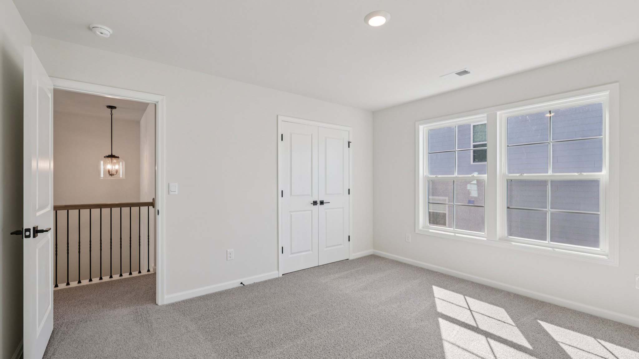 Carpeted bedroom with window