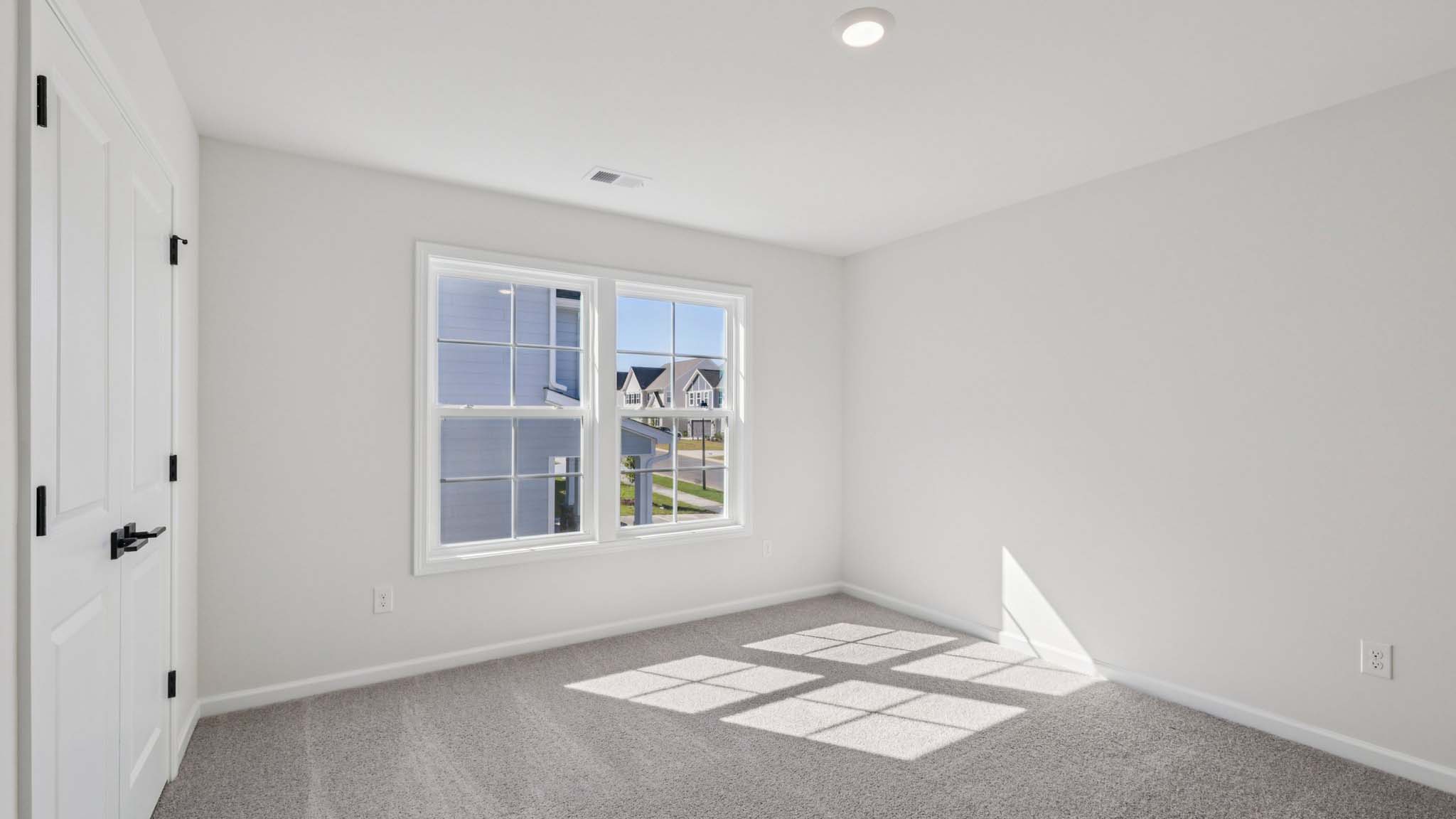 Carpeted bedroom with window