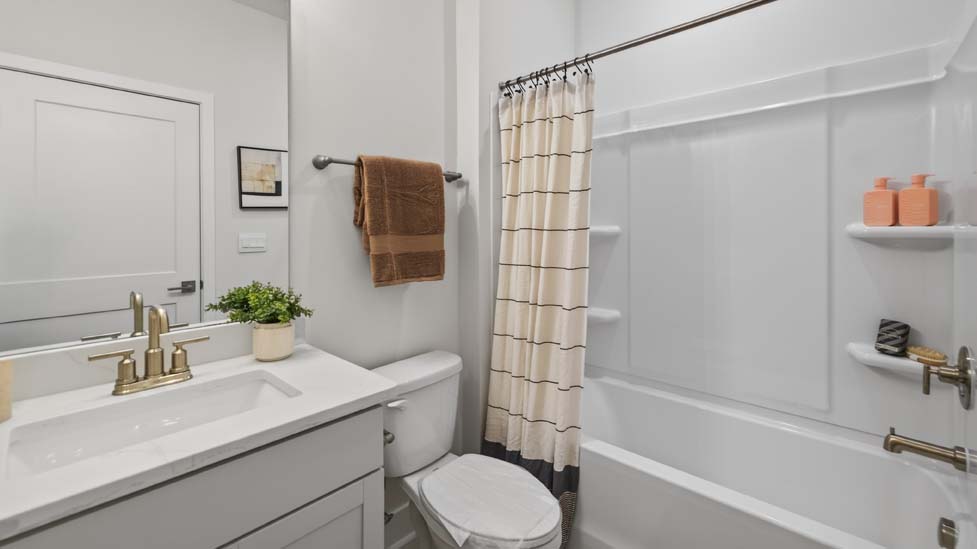 Bathroom with double sink vanity and shower tub combo