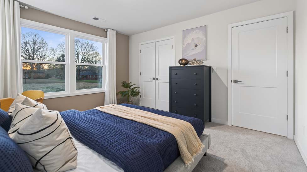 Carpeted bedroom with window