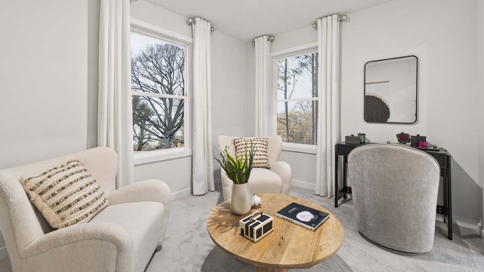 Primary carpeted bedroom with large windows