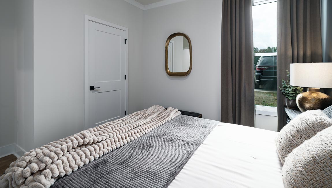 Carpeted bedroom with windows
