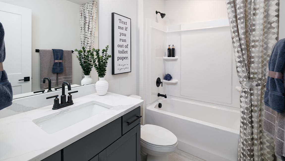 Bathroom with white counters, and cabinets and bathtub
