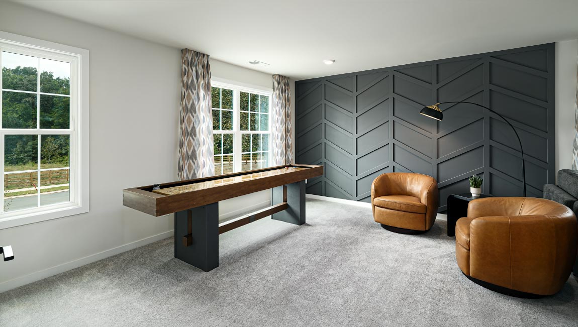 Loft space with carpet and two large windows