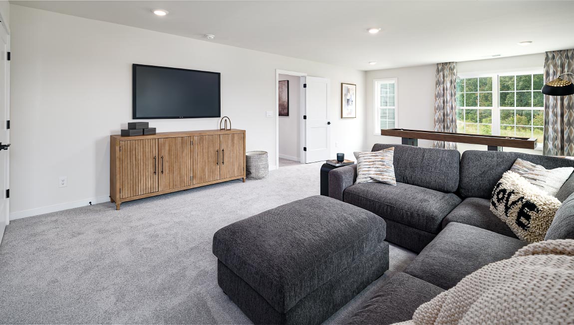Loft space with carpet and two large windows