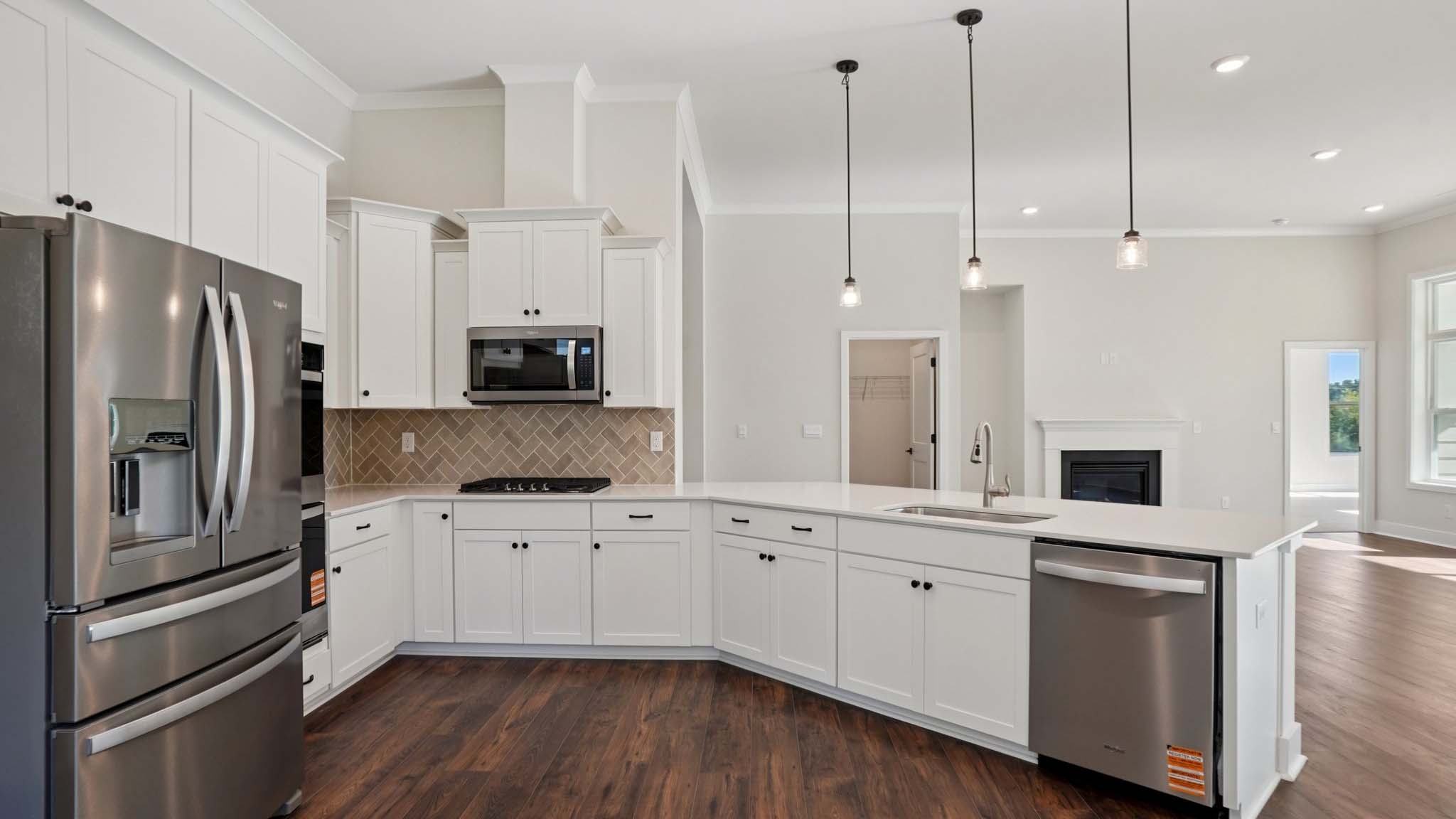 Kitchen and island with cabinets and stainless steel appliances