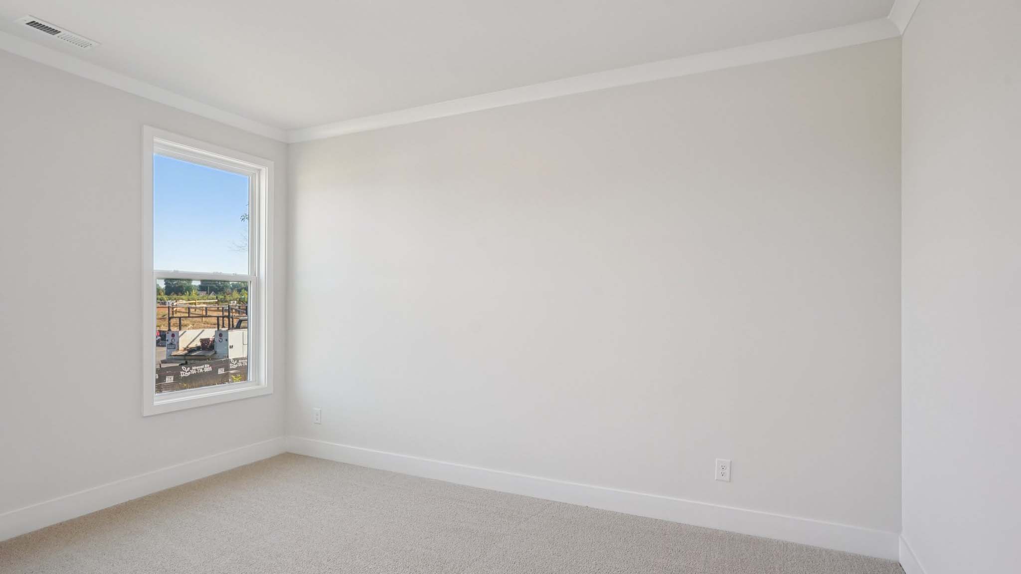 Carpeted bedroom with windows