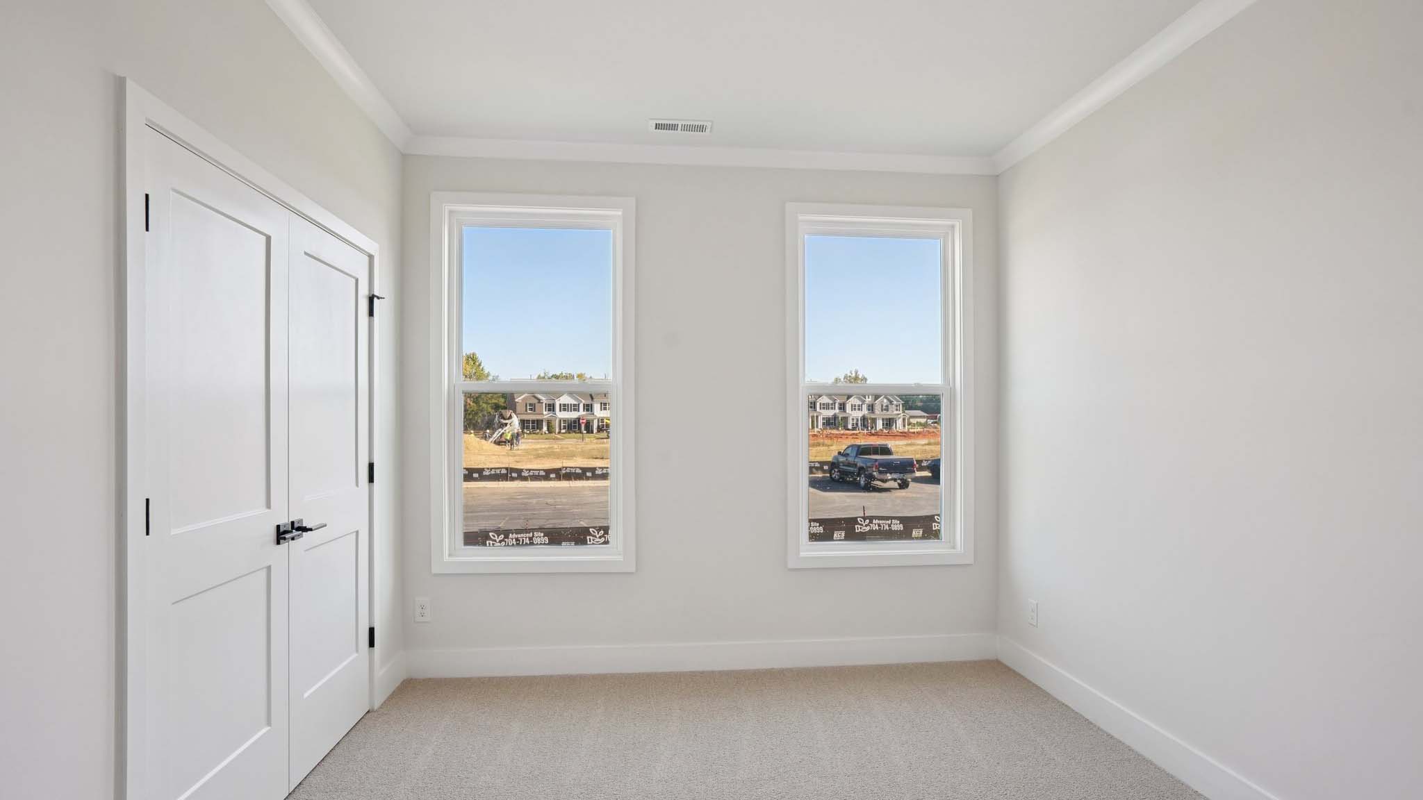 Carpeted bedroom with windows