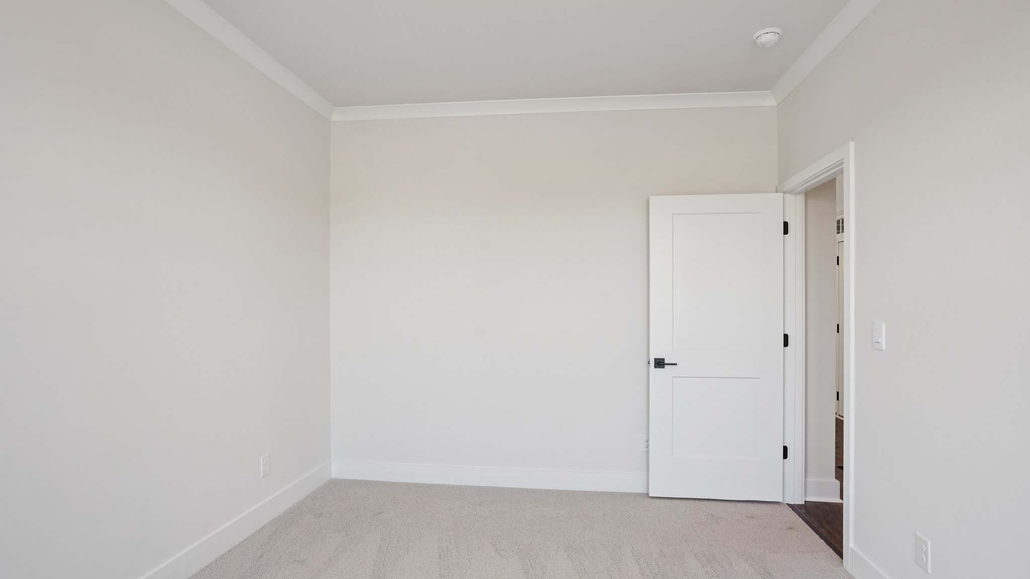 Carpeted bedroom with windows