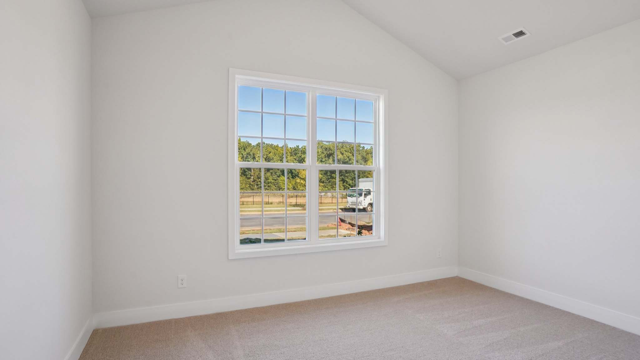 Carpeted bedroom with windows