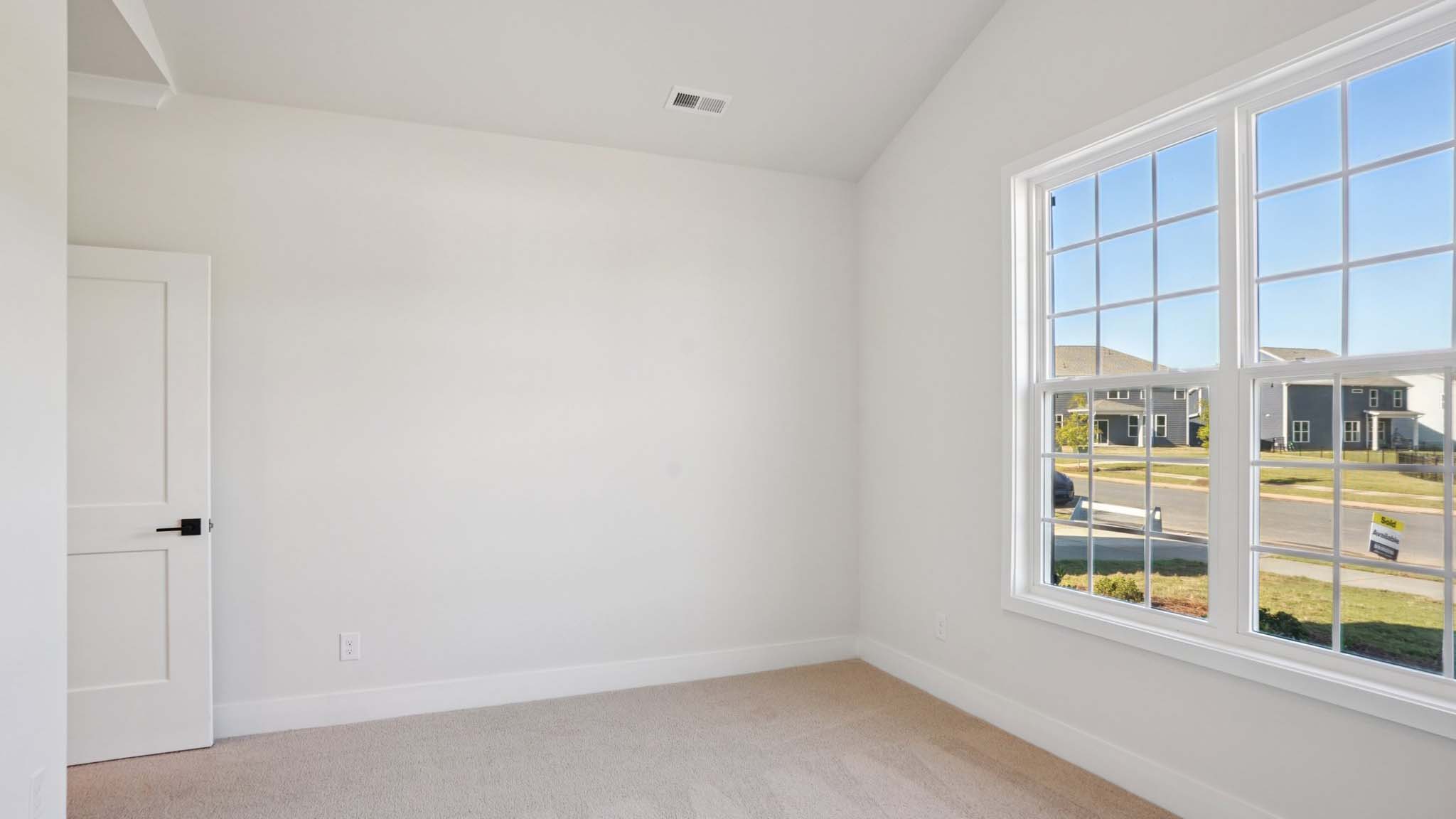 Carpeted bedroom with windows