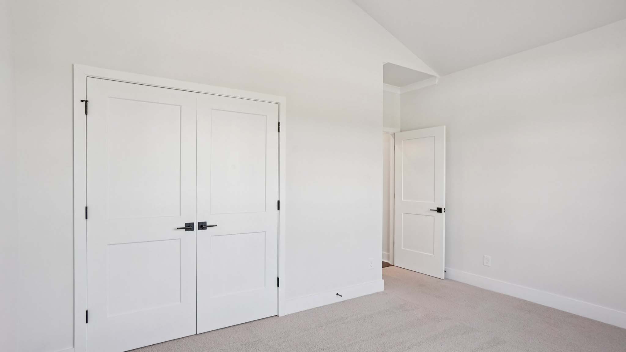 Carpeted bedroom with windows