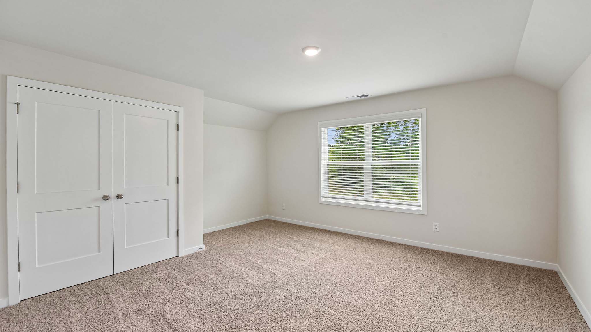 Carpeted bedroom with windows