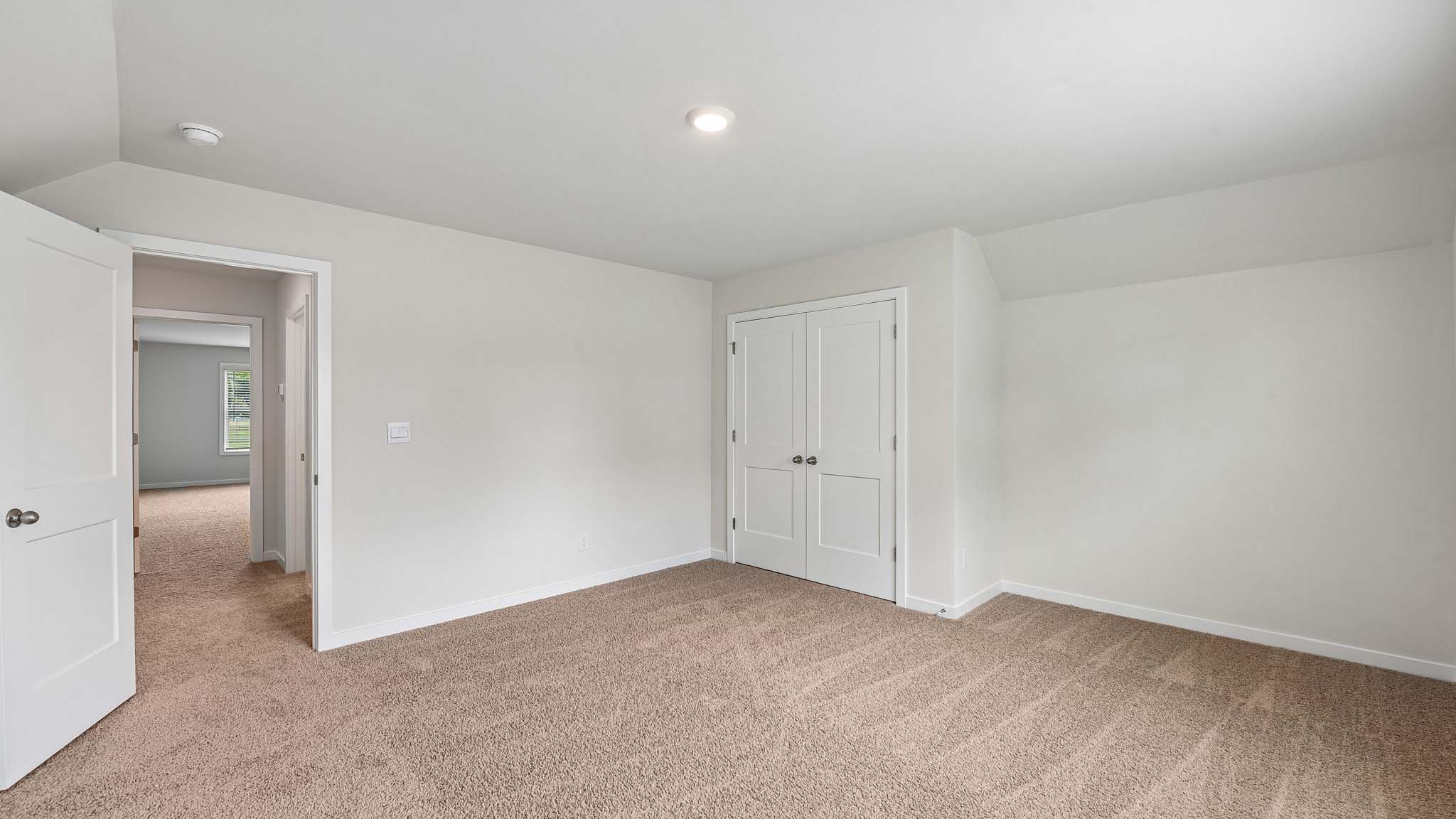 Carpeted bedroom with windows