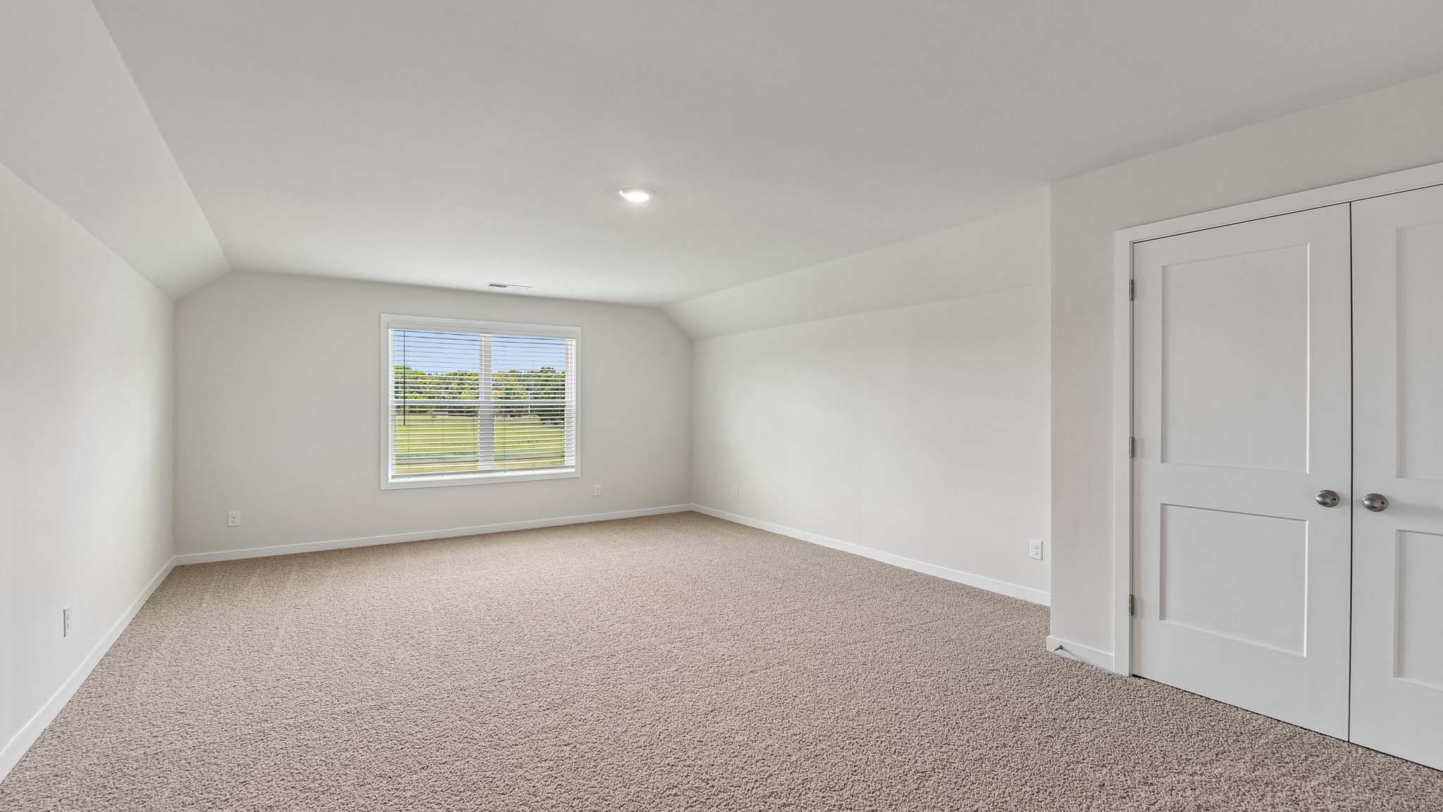 Carpeted bedroom with windows