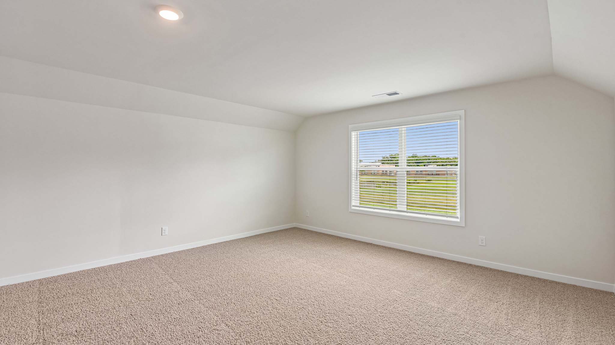 Carpeted bedroom with windows