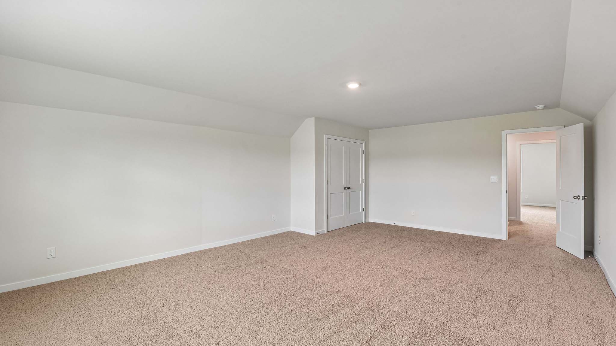 Carpeted bedroom with windows