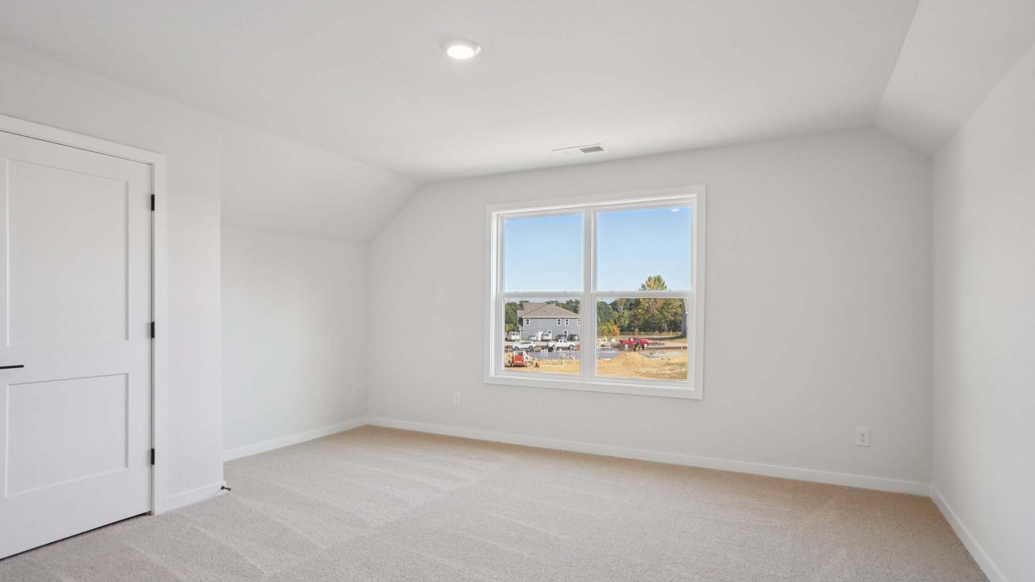 Carpeted bedroom with windows