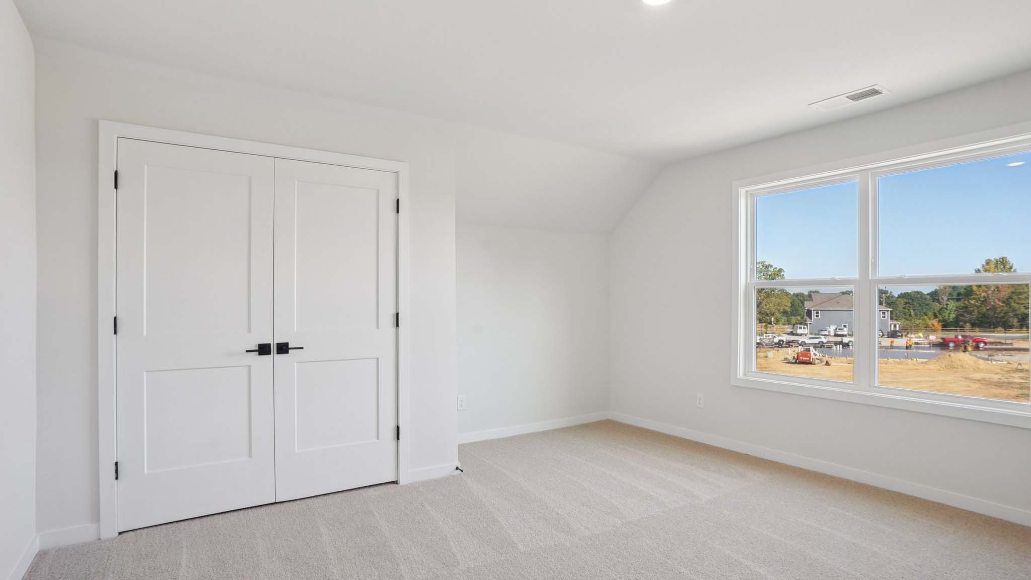 Carpeted bedroom with windows