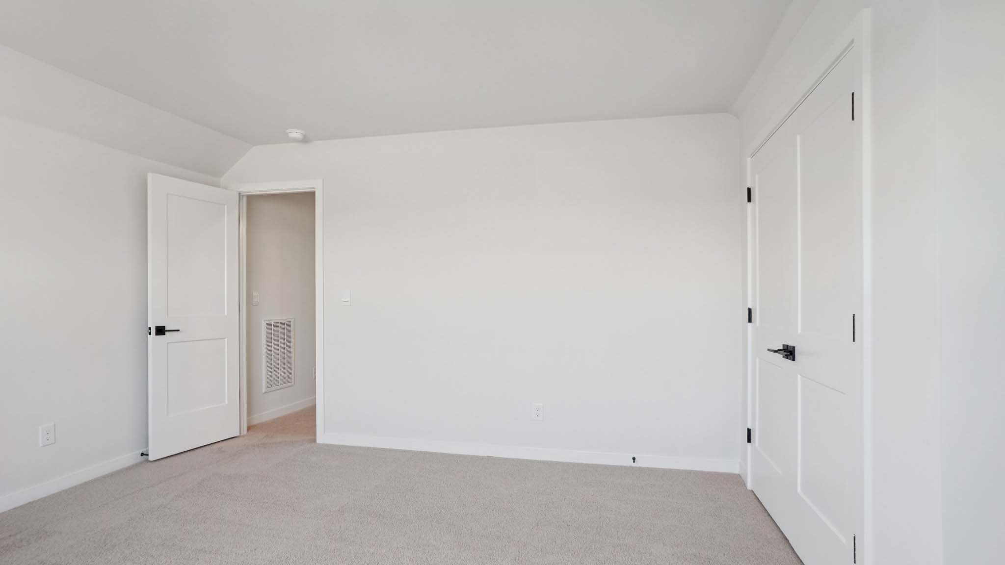 Carpeted bedroom with windows
