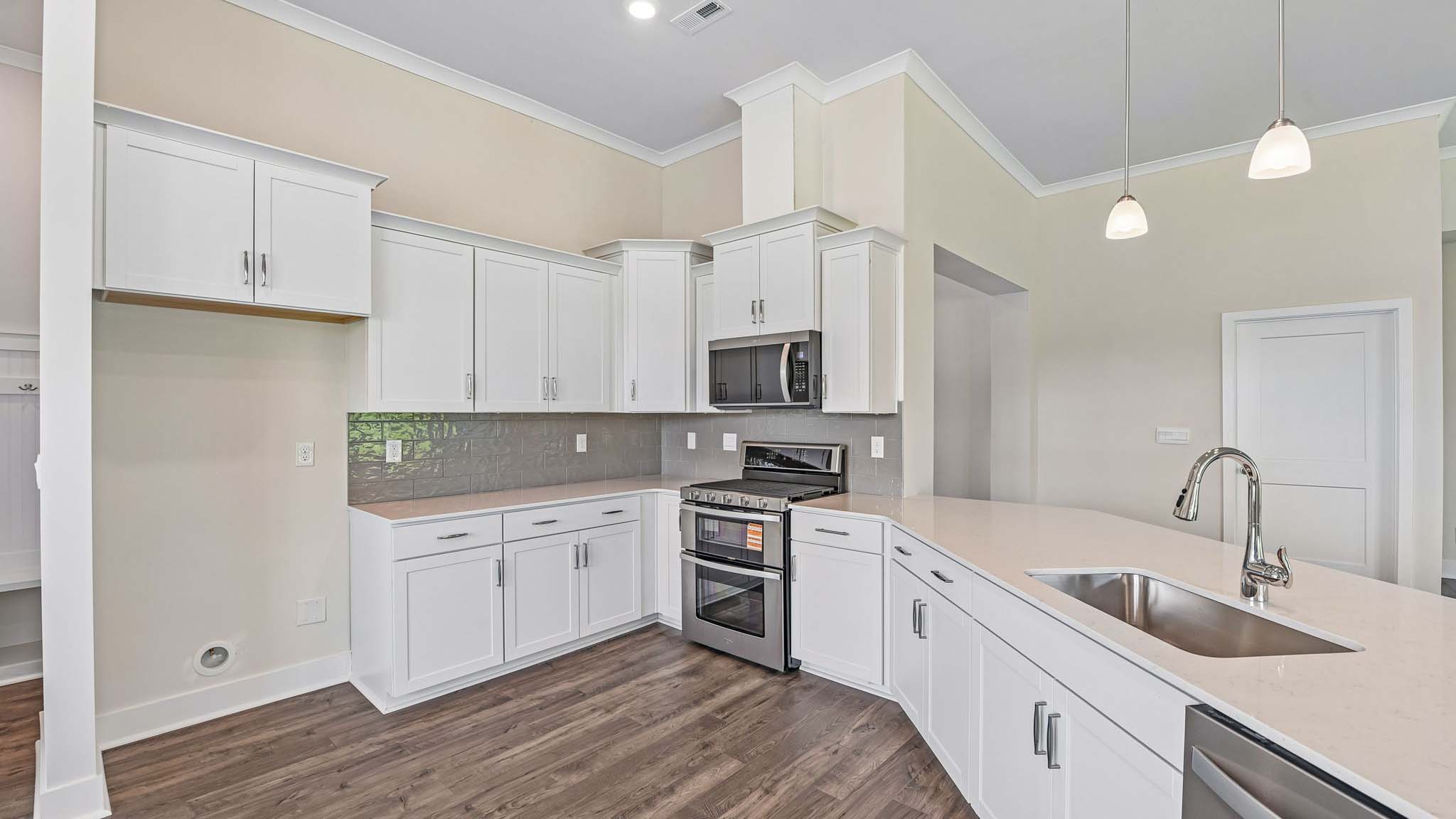 Kitchen and island with cabinets and stainless steel appliances