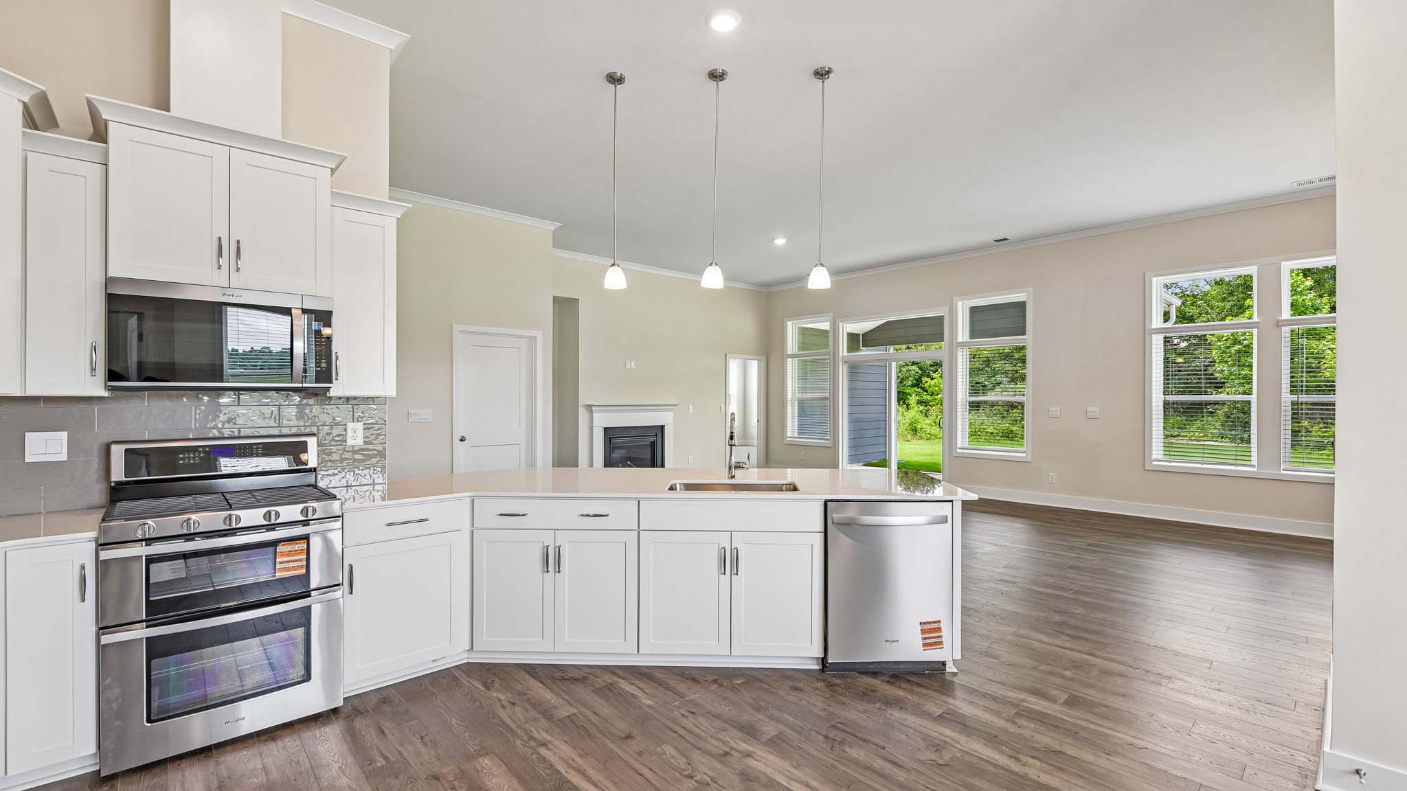 Kitchen and island with cabinets and stainless steel appliances