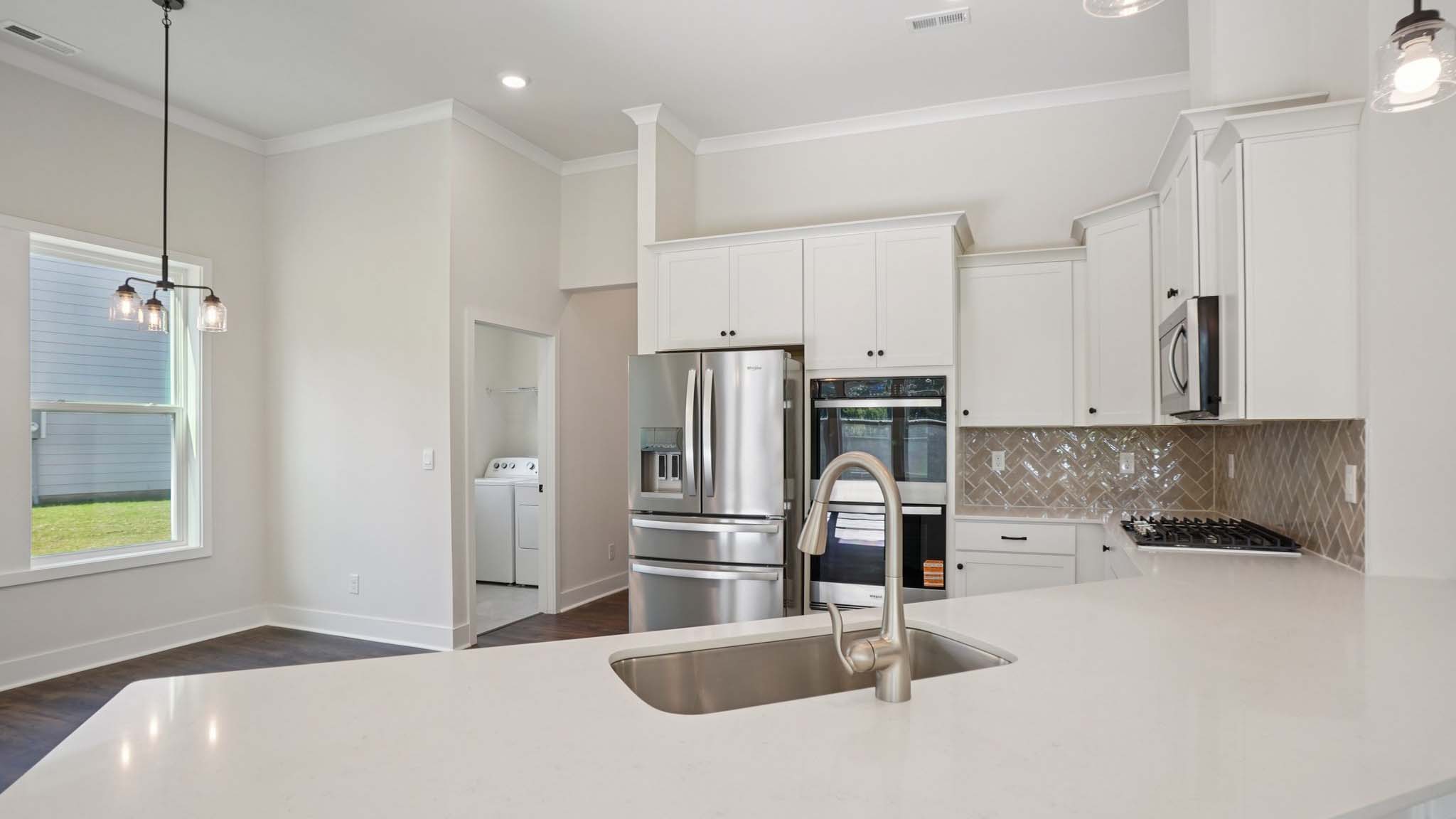 Kitchen and island with cabinets and stainless steel appliances