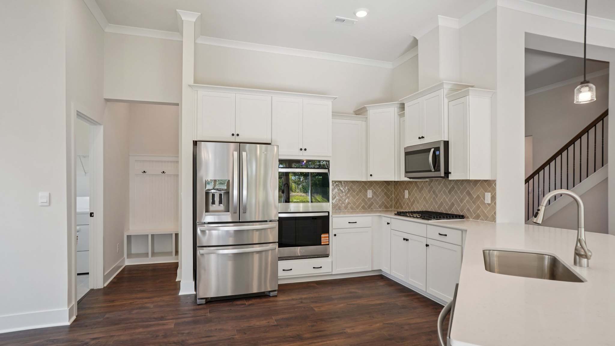 Kitchen and island with cabinets and stainless steel appliances
