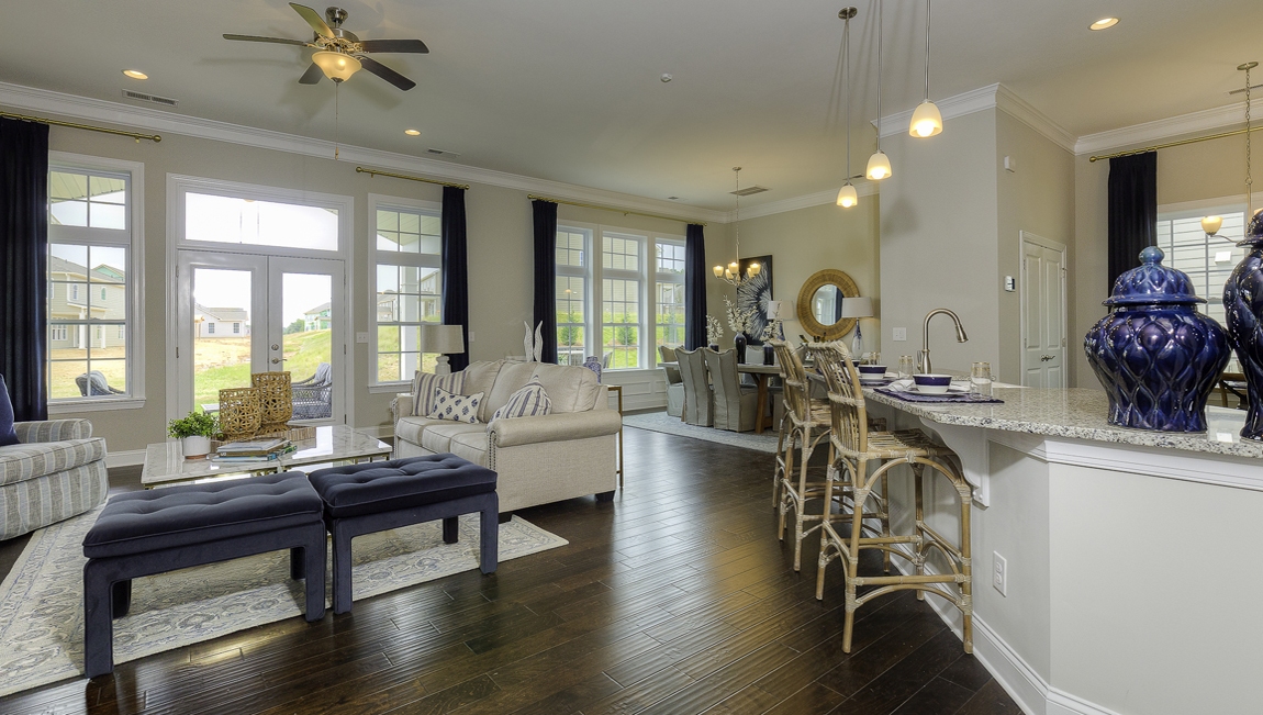 Open family room beside kitchen with fireplace