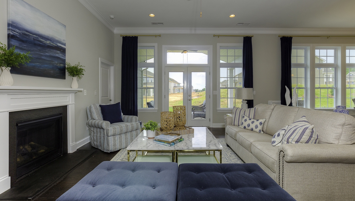 Open family room beside kitchen with fireplace
