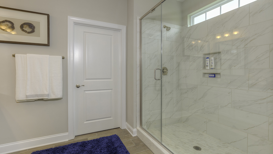 Primary bathroom with large glass door shower