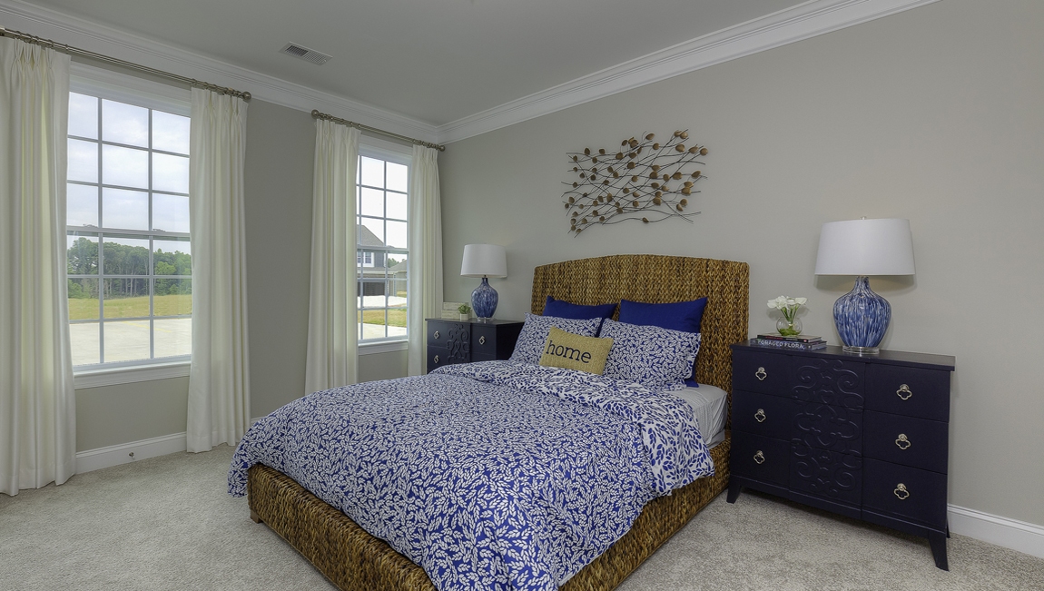 Carpeted bedroom with large windows