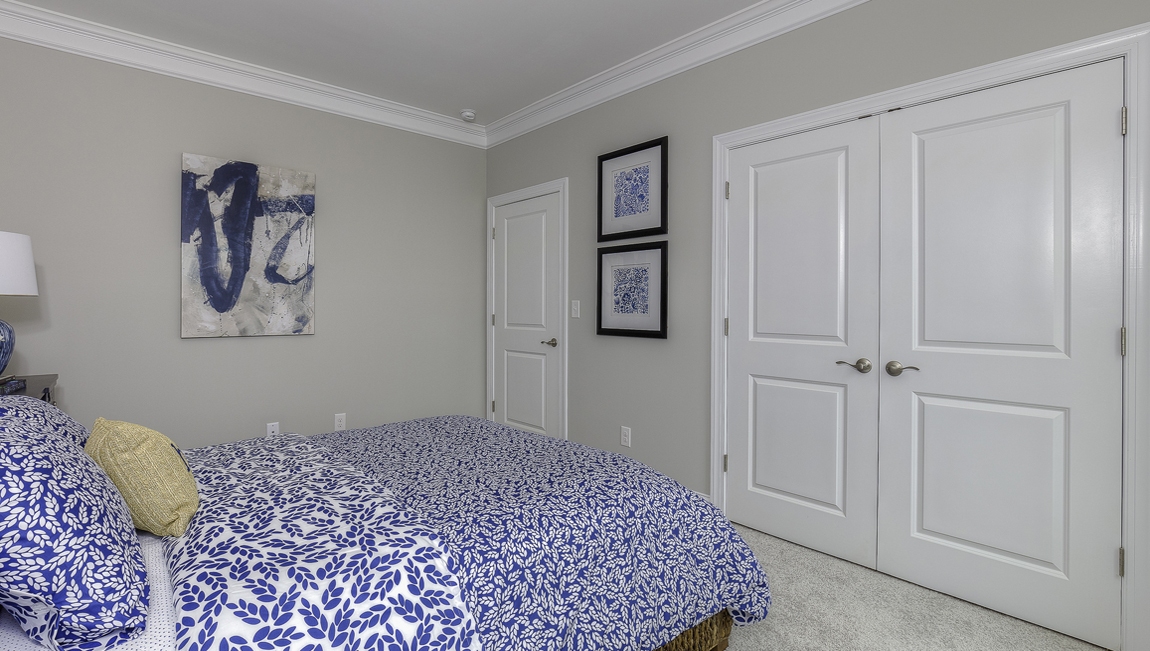 Carpeted bedroom with large windows