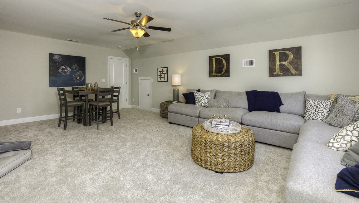 Carpeted bedroom with large windows