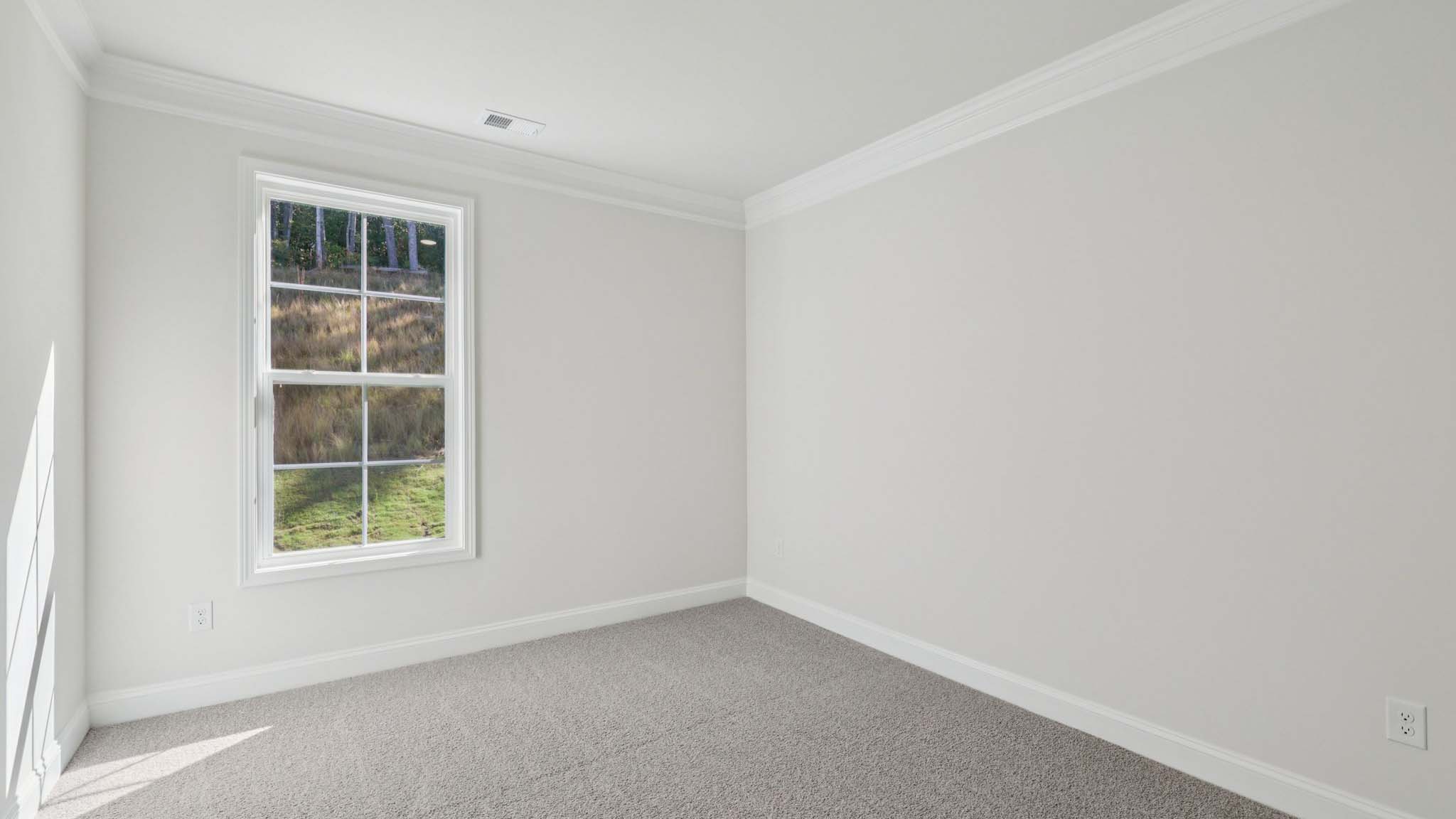 Carpeted bedroom with windows