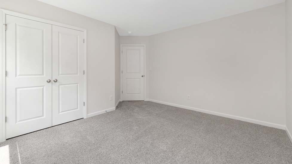 Carpeted bedroom with large window