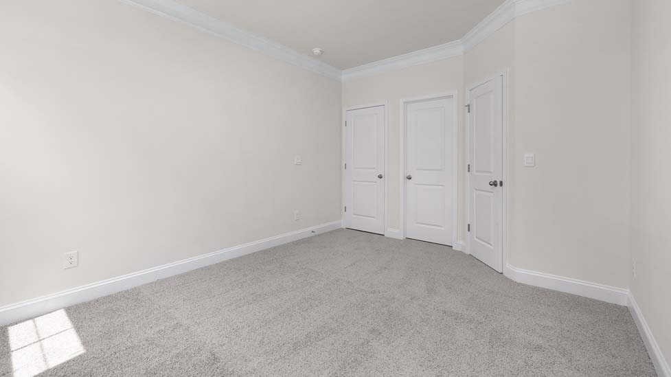 Carpeted bedroom with large window