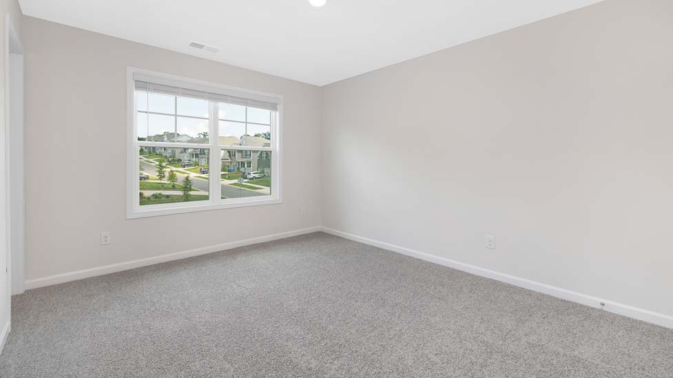Carpeted bedroom with large window