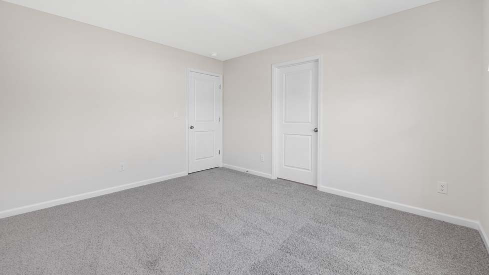 Carpeted bedroom with large window
