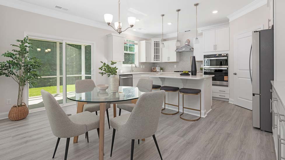 Kitchen and island with white cabinets, white rest of kitchen has brown cabinets