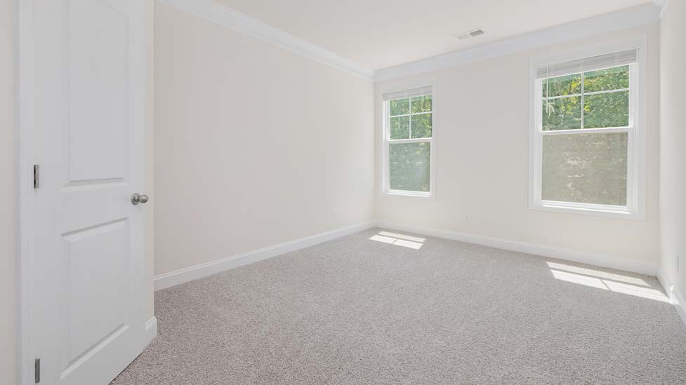 Carpeted bedroom with large window