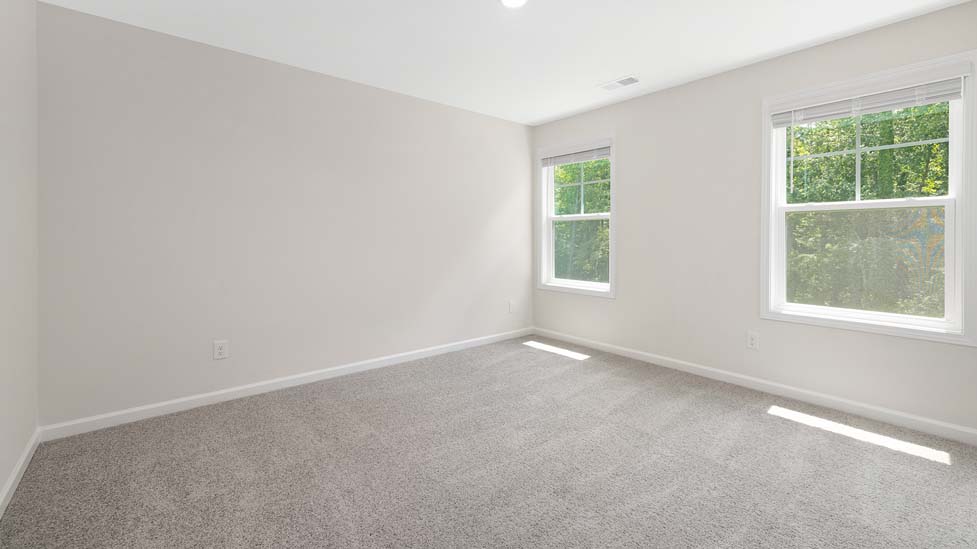 Carpeted bedroom with large window
