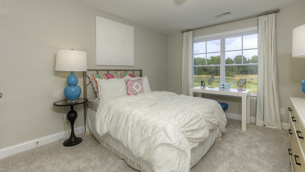 Carpeted bedroom with large window
