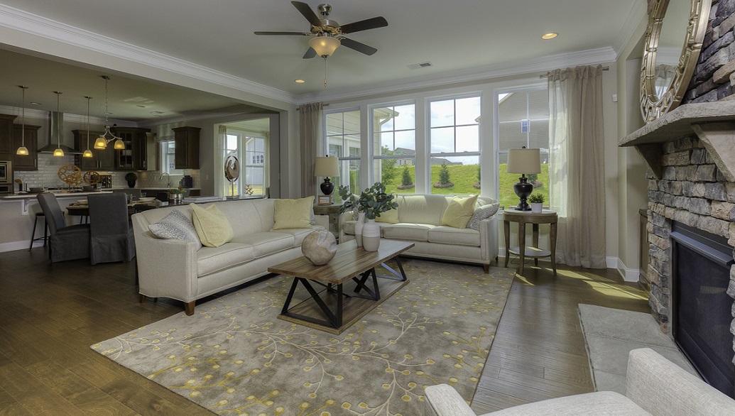 Modern, open-concept Family room with wood floors, fireplace, and large windows