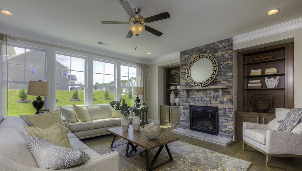 Modern, open-concept Family room with wood floors, fireplace, and large windows