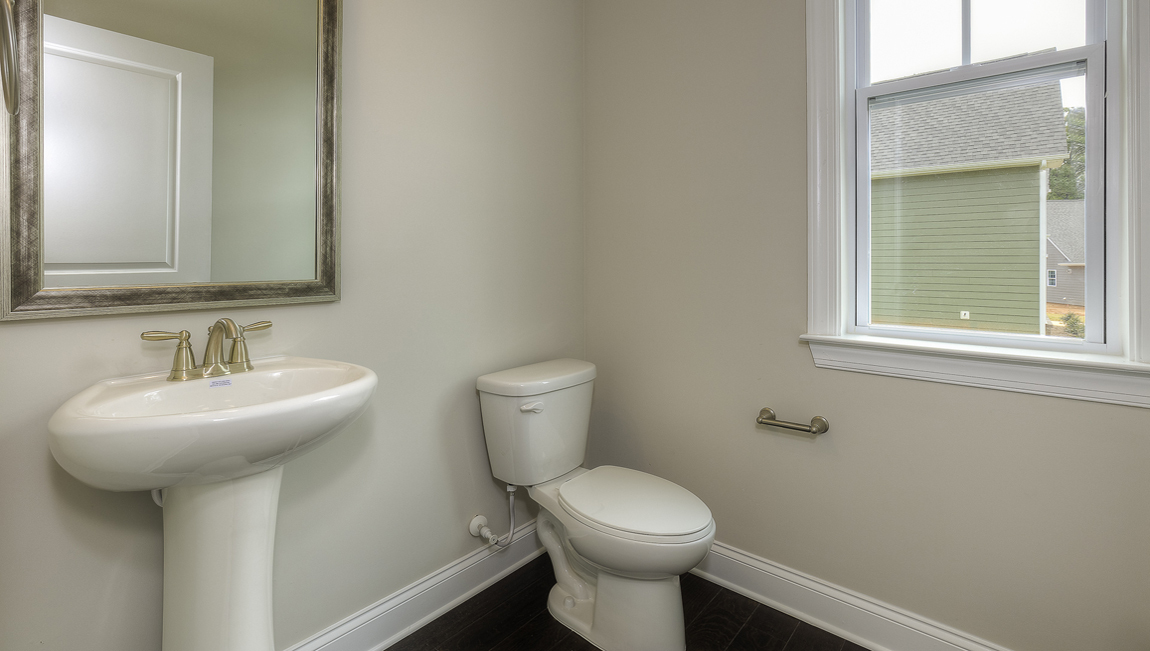 Powder bathroom with sink and toilet and small window