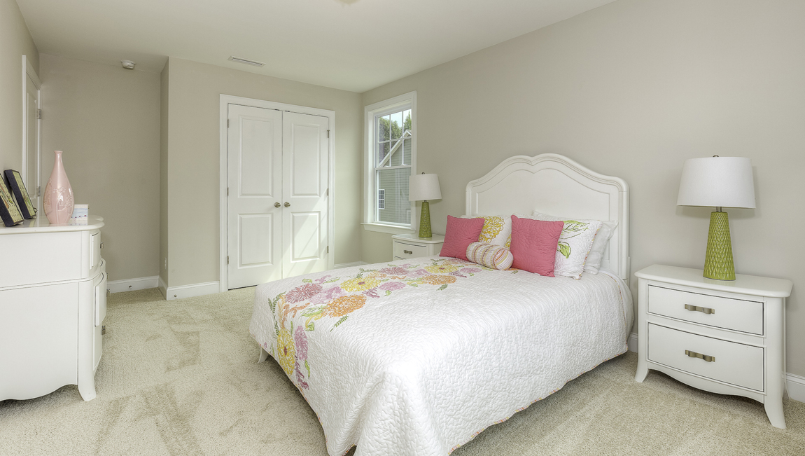 Carpeted bedroom with two large windows